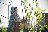 Muslim woman with flowers and picnic basket