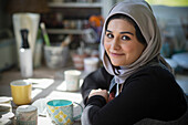 Female artist in hijab in art studio