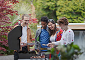 Happy couple friends at barbecue grill on patio