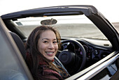 Happy woman in convertible