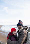 Happy hiker couple above ocean beach