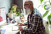 Man with beard using computer in home office