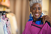 Happy senior woman shopping in clothing shop