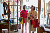 Women friends entering clothing boutique