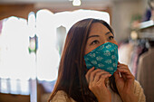 Woman wearing face mask in shop