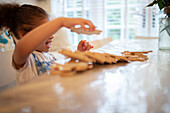 Girl playing with wood jigsaw pieces