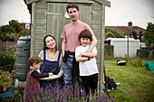 Happy family next to shed