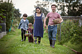 Family with baskets on allotment