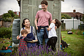 Happy family laughing at garden shed