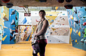 Confident young woman at climbing center