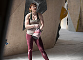 Young female rock climber with chalk bag