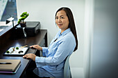 Businesswoman with zen garden in office