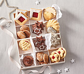 Assorted Christmas biscuits in compartments of a biscuit box