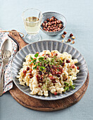 Spelt gnocchi with bacon and hazelnuts