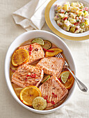 Salmon marinated in citrus juice with potato and apple salad