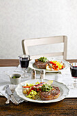 Rib-eye steaks with roasted roots and parsley pesto