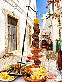 Laid table with grilled dishes, restaurant, Olhao, Faro, Portugal