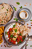 Indian style dinner greek yoghurt baked tomatoes baked chickpeas with harrisa grilled halloumi naan breads