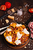 Tagliatelle with meat sauce, buratta, and parmesan cheese