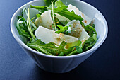 Rocket salad with parmesan in a bowl