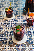 Sparkling Red Sangria with glass straws on Portuguese tiled surface