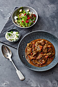 Stew cooked in a Moroccan tagine with salad and a mint dip