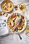 Oven-baked gilthead with Mediterranean vegetables and lemons