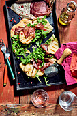 Pizza with bresaola, ruccola, pomegranate and grilled pears