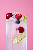 Iced summer lemonade with red fruit and lime