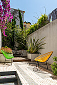 Colourful chairs in an urban summer courtyard terrace