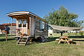 Refurbished caravan, in front of it terrace with awning in the garden