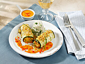 Vegetarian courgette roulades in a paprika sauce