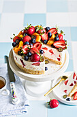No bake strawberry cheesecake decorated with fresh strawberries, blueberries and apricots