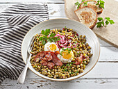 Lentil stew with egg and bacon