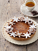 Chocolate caramel Christmas cake decorated with gingerbread cookies