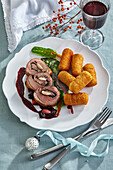 Christmas duck breast roulade with almonds and croquettes