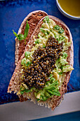 Roast bread with avocado-potato puree, caviar and mint