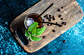 Frothy Whipped Coffee White Russian cocktail served in the glass and decorated with coffee beans and fresh mint leaves