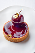 Red wine and cherry tartlet with gold leaf
