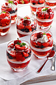 Strawberry jelly with whipped cream and red fruits