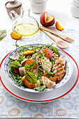 Salad with grilled chicken, peaches, and arugula