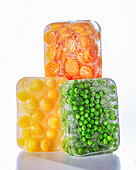 Peas, apricots, and carrots in ice blocks