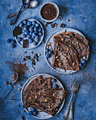 Cocoa pancakes with blueberries and chocolate
