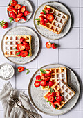 Waffles with strawberries, sage and powdered sugar