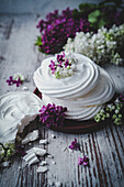 Mini meringue surrounded by lilac blossoms