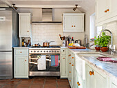 Light country kitchen with terracotta floor