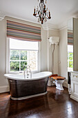 French-style freestanding bathtub in front of a window