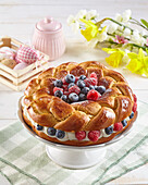 Easter yeast wreath with pudding cream and berry fruit