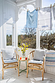 Sitting area and clothesline with towels on a sunny veranda