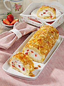 Bee sting sponge cake roll with strawberry pieces